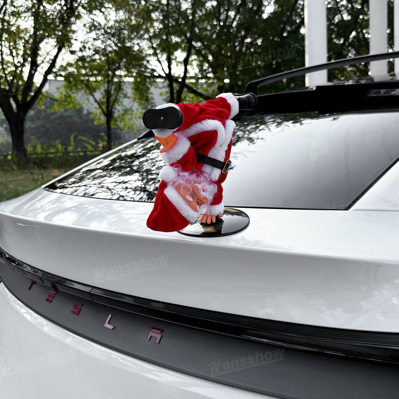 Santa Claus in action with music in Tesla Model Y trunk